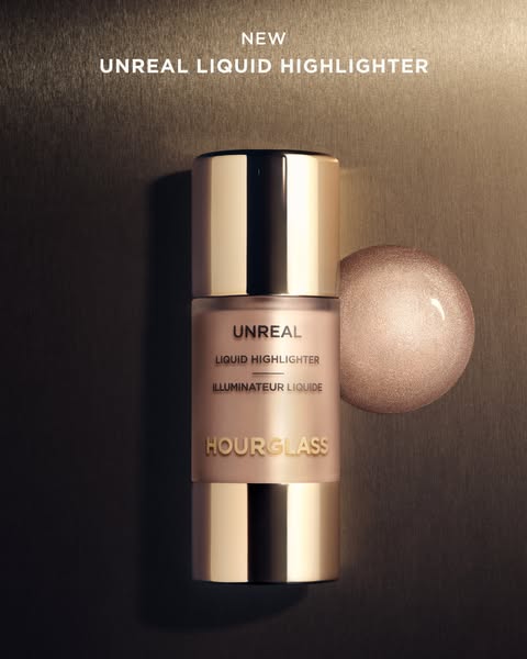 Close up of Hourglass Unreal Liquid Highlighter next to a drop of the product.
