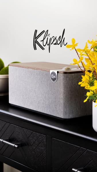 This image ad showcases a Klipsch tabletop speaker as a stylish addition to modern home decor. The clean, well-lit shot 