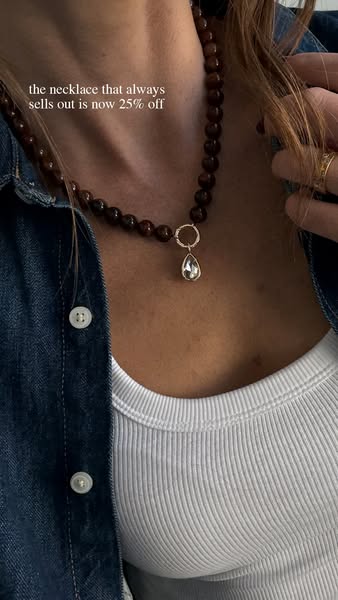 A close-up shot focuses on a necklace worn by a woman. The text overlay indicates a sale on the necklace.