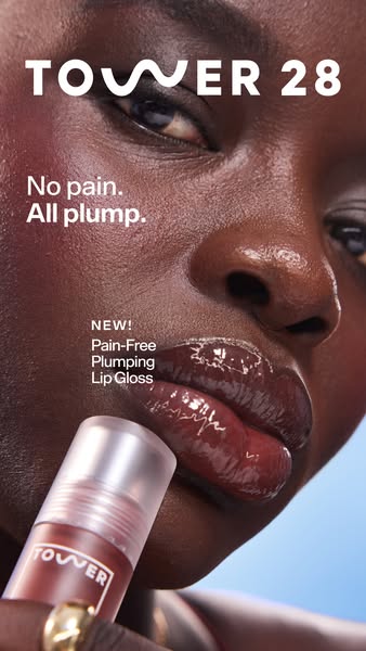 This ad is for Tower 28's Pain-Free Plumping Lip Gloss. It features a close up of the gloss on the lips of a woman. 