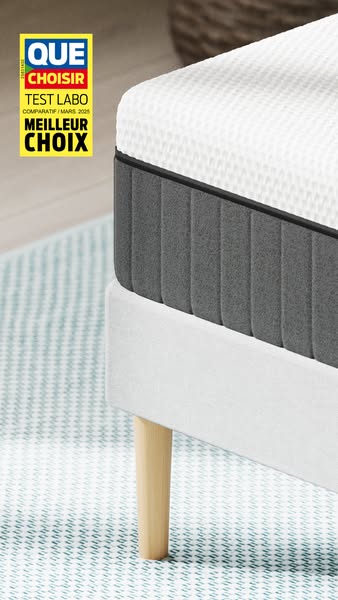 This ad features a close-up shot of a mattress on a bed frame, highlighting its construction and materials. A badge in t