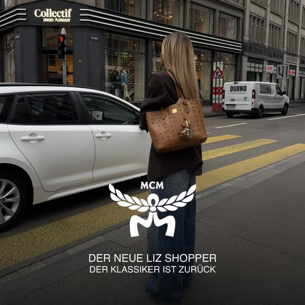 This image ad promotes the MCM Liz Shopper bag. The ad features a woman walking on a city street carrying the bag on her
