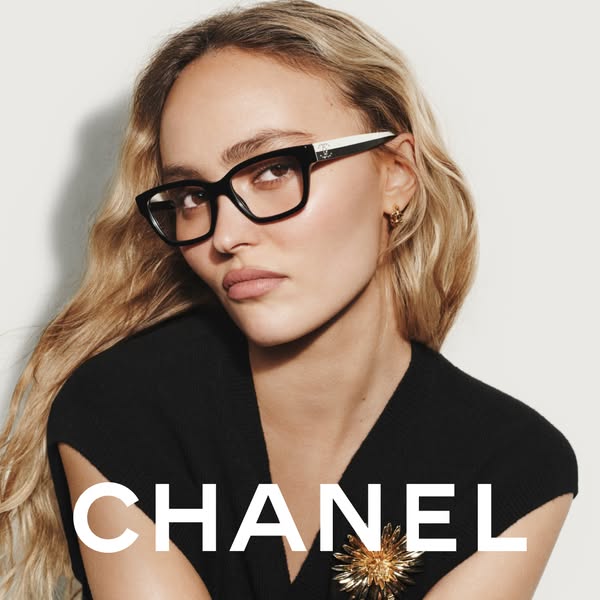 A close-up of a person wearing Chanel glasses. The brand's name is written in large, white font on the bottom half o