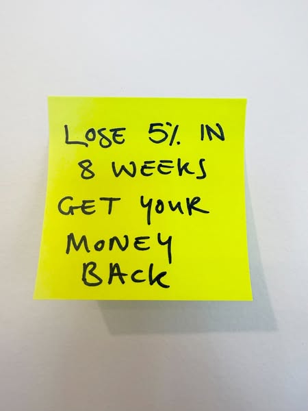 An image of a yellow sticky note is shown against a white background. Handwritten on the sticky note in black pen is the