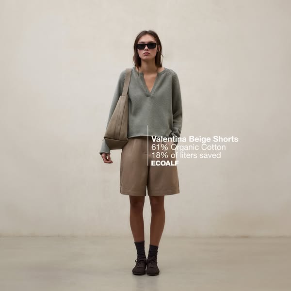 This ad showcases a woman modeling beige shorts made from 61% Organic Cotton. It highlights the brand's commitment t