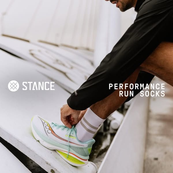 This image ad highlights the Stance brand's performance run socks, showing a runner tying their shoe to emphasize th