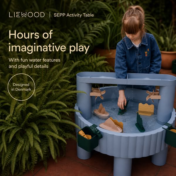 This image ad showcases the LIEWOOD SEPP Activity Table being used by a young girl to play in a backyard setting. The ad