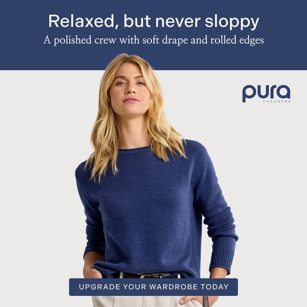 An image ad promoting Pura Cashmere. The ad features a woman modeling a blue cashmere sweater paired with light-colored 