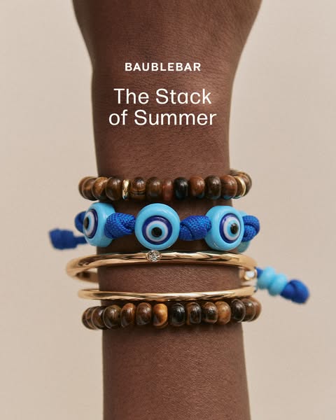 This image ad showcases a stack of Baublebar bracelets on a dark-skinned model's forearm. The focal point is the var