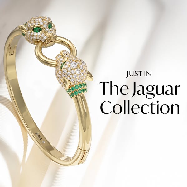 This ad showcases a gold bangle from the Jaguar Collection. The bangle features two jaguar heads adorned with diamonds a