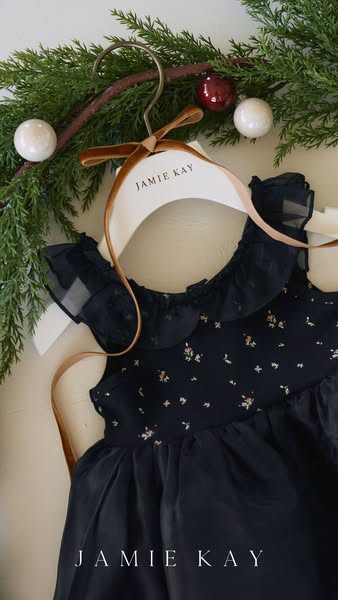 This ad showcases a Jamie Kay dress in a festive holiday setting, emphasizing the brand's aesthetic and product qual