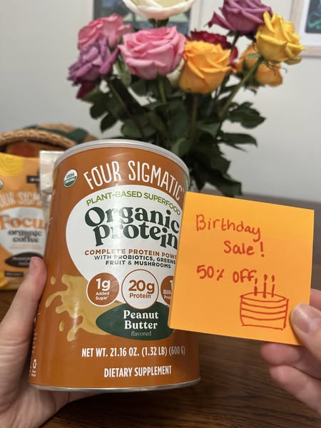 This ad features a can of Four Sigmatic Organic Protein Peanut Butter flavored protein powder along with a handwritten s