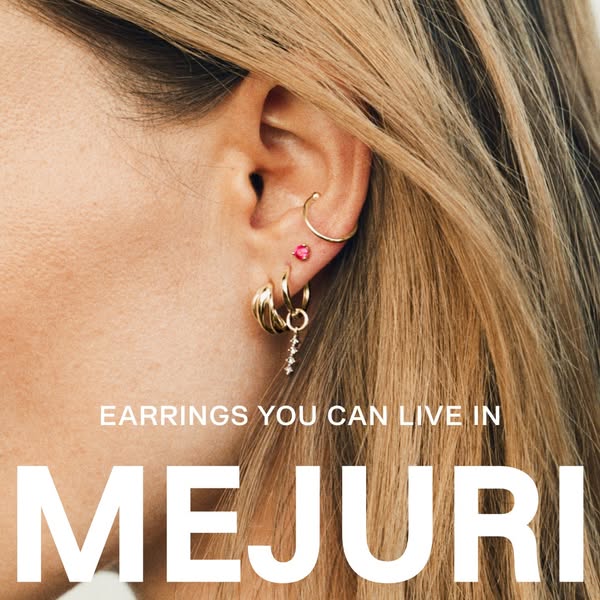 This ad for Mejuri features an extreme close-up of a woman's ear, showcasing multiple earrings worn at once to promo