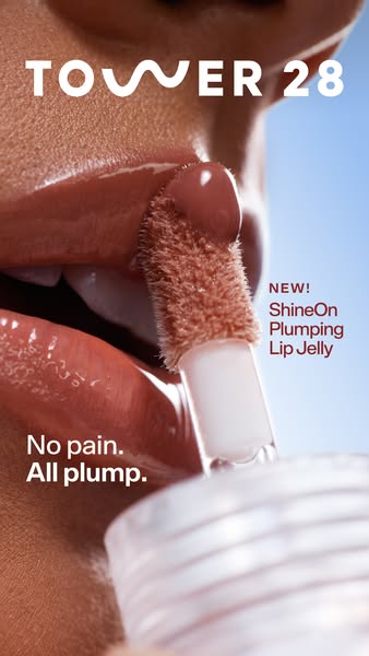 This ad demonstrates the Tower28 ShineOn Plumping Lip Jelly. The image shows an extreme closeup of the lip jelly applica