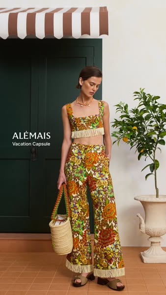 A static image ad for Alémais' Vacation Capsule Collection features a model wearing a floral print crop top and matc