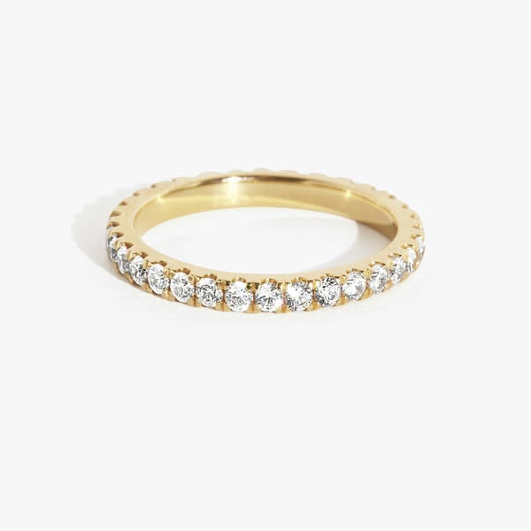 This ad features a close-up shot of a gold ring with diamonds, set against a white background.