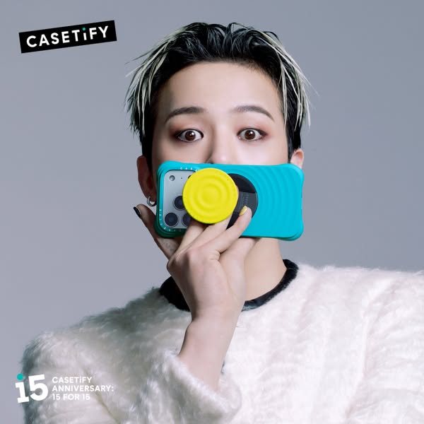 The ad features a person holding a CASETiFY phone case with a PopSocket on it. It highlights the brand's anniversary