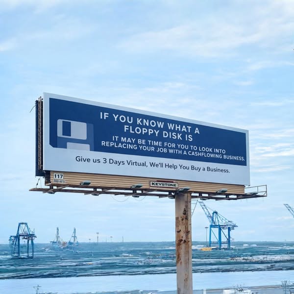 This ad features a billboard with a floppy disk image and a message about replacing your job with a cash flowing busines