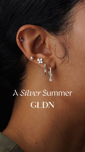 The ad showcases GLDN jewelry with a focus on silver earrings. The ad highlights the earrings by featuring a close-up of