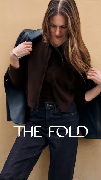 This ad features a woman wearing clothing from The Fold, highlighting the brand's apparel.