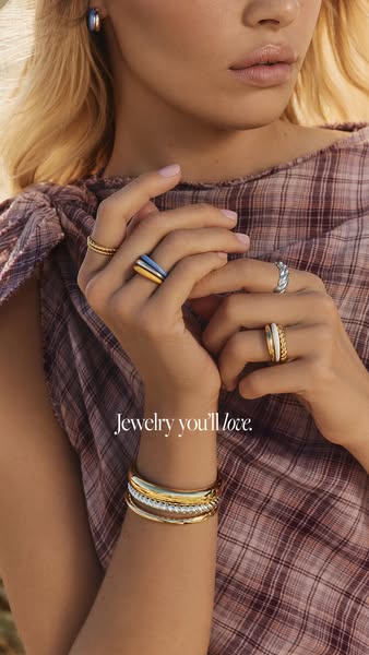 This ad highlights the brand's jewelry collection through a close-up shot of a model wearing various rings and brace