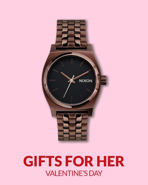 The ad showcases a Nixon watch against a light pink background, promoting it as a Valentine's Day gift for her. The 