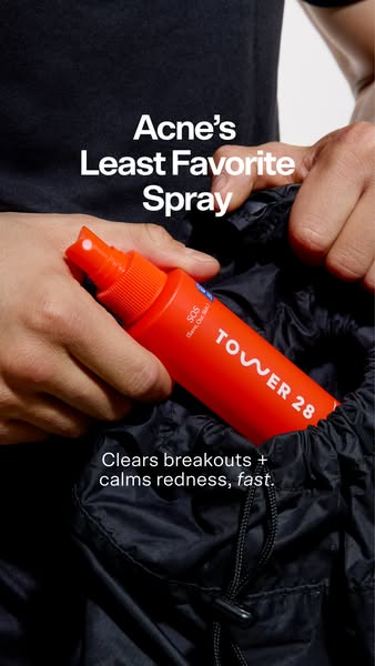 The ad showcases Tower 28's SOS spray as a go-to solution for acne breakouts and redness. The image highlights the c