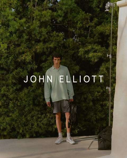 This ad features a man standing in front of a green plant wall, wearing John Elliott clothing. The ad emphasizes the bra