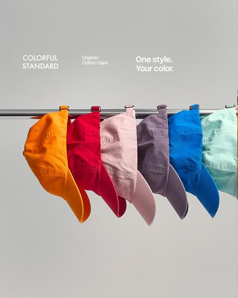 This image ad showcases a range of colorful cotton caps hanging on a rack. The ad uses a clean, minimalist approach to h