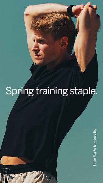 A man wearing a black Stride Flex Performance Tee stretches his arms, showcasing the brand's spring training staple.