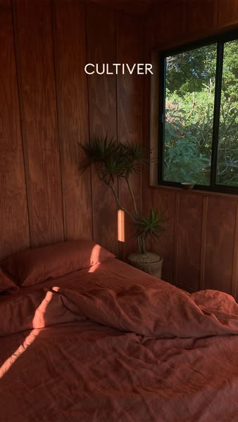 The ad showcases Cultiver's linen bedding set in a warm, inviting bedroom setting. The composition focuses on the pr