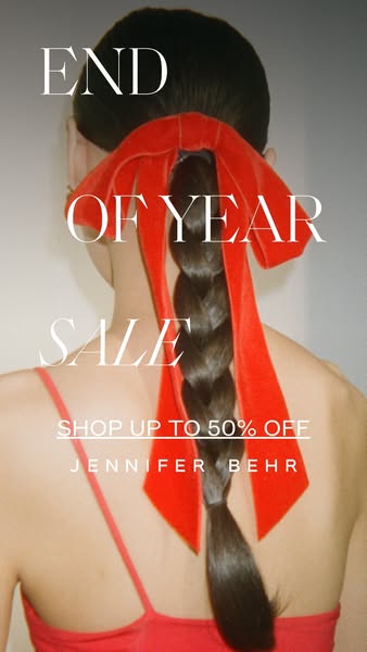 This image ad for Jennifer Behr promotes an end-of-year sale, featuring a model with a long braid adorned with a large r