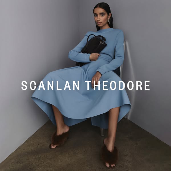 This ad features a woman elegantly posing in Scanlan Theodore clothing and accessories against a neutral backdrop. The f