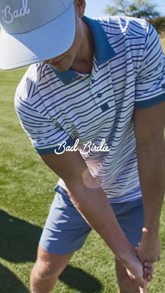 This image ad features a close up shot of a man swinging a golf club. He is wearing a Bad Birdie polo shirt, shorts, and