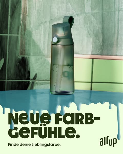 This image ad features a gray AllUp water bottle sitting on a light blue, reflective surface. The copy reads, "Neue