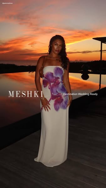 This ad showcases a woman in a long, cream-colored strapless dress with an orchid design. She is posed outdoors during a