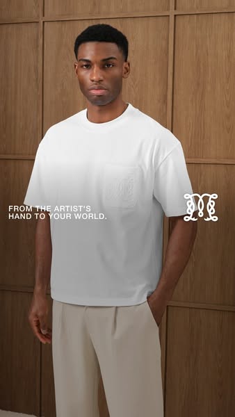 The ad features a Black male model wearing a white t-shirt. The t-shirt has a decorative logo on the pocket. The message