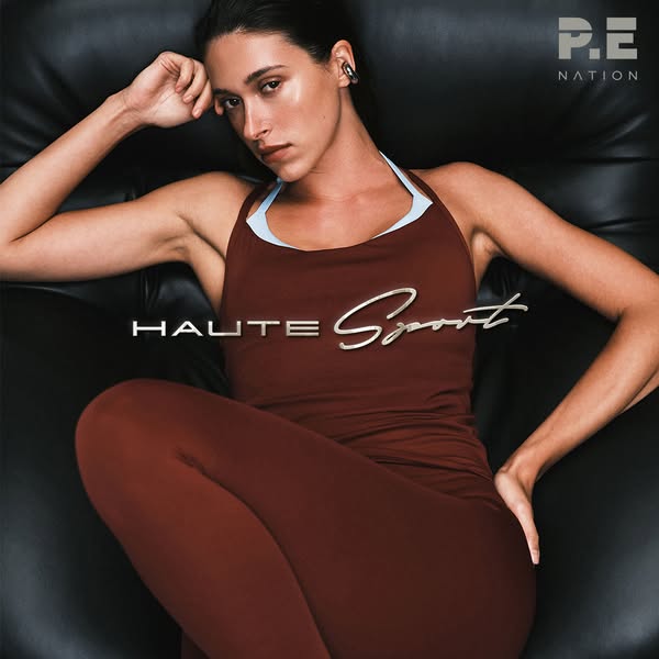 This ad features a woman wearing a P.E Nation exercise outfit, sitting on a black leather couch. The ad aims to convey t