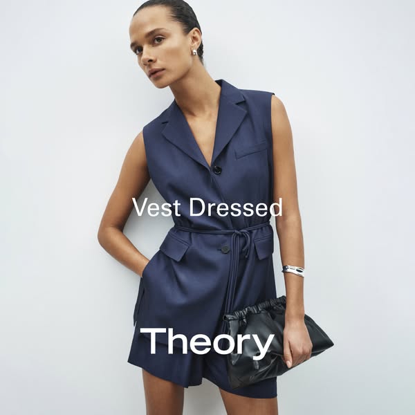 The ad features a woman modeling a sleeveless navy blue blazer dress with a tied waist and a black purse, promoting the 