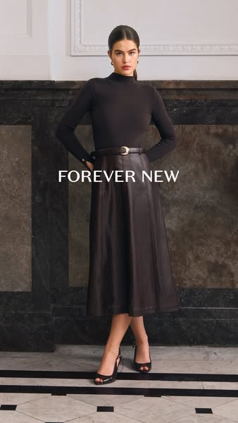 This Forever New ad features a woman modeling a long, brown skirt and top, paired with black heels. The ad focuses on th