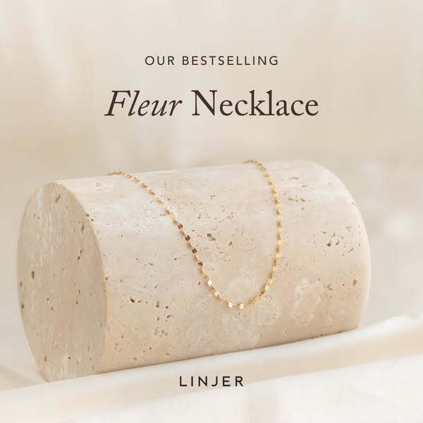 This ad features the LINJER brand's 'Fleur Necklace.' The main focal point of the ad is an artistic display 