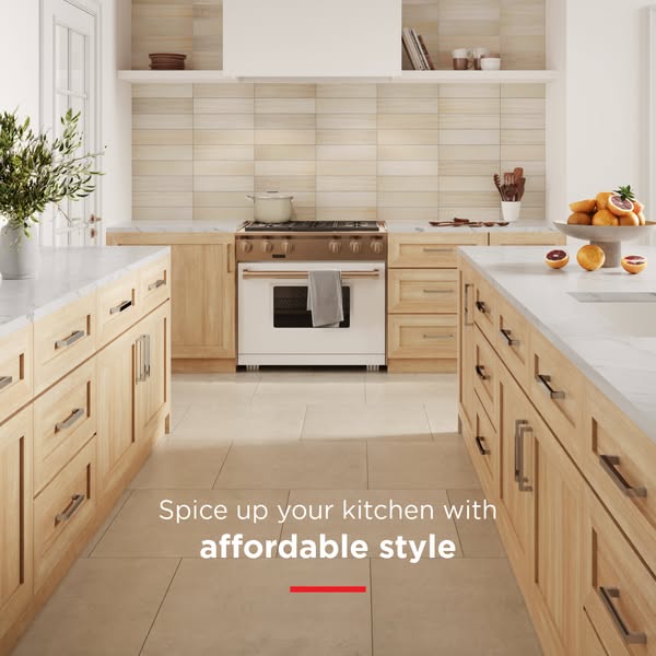 This ad features a kitchen with light wood cabinets, light colored tile flooring, light beige backsplash, and white marb