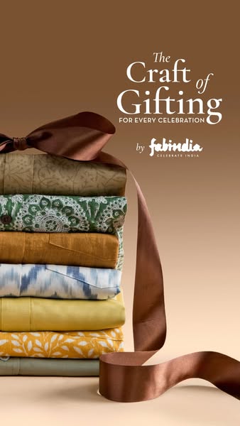 This ad showcases a stack of folded Fabindia clothing tied together with a decorative ribbon. The ad promotes Fabindia a