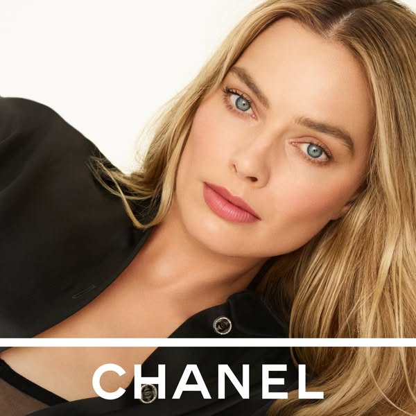 This ad features model Margot Robbie showcasing Chanel makeup. The ad uses a simple background to focus on the talent. T