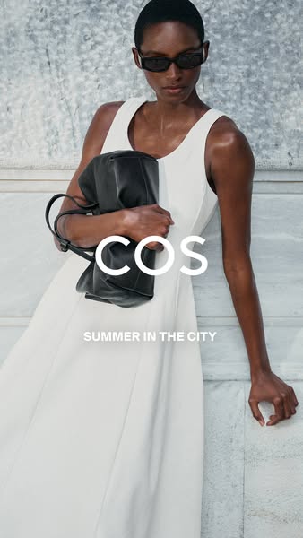 This image ad promotes the brand COS and features a model wearing a white dress and carrying a black handbag.
