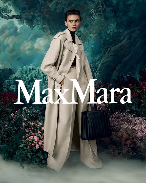 This image ad features a high-fashion, full body shot of a model wearing Max Mara apparel and holding a Max Mara handbag