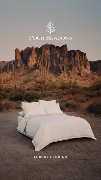 This ad for Four Seasons promotes their luxury bedding. The ad features a bed with white luxury bedding in a desert land