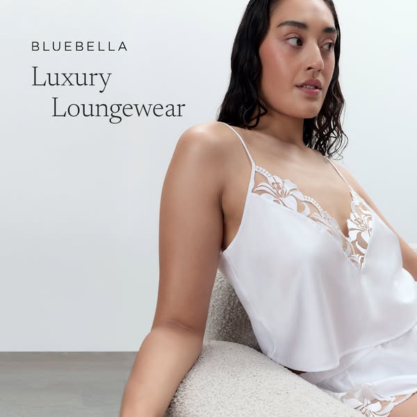 This ad is for BLUEBELLA and features a model wearing white luxury loungewear. The ad highlights the brand and the produ
