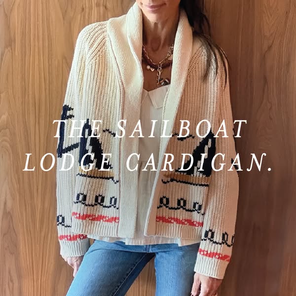 This image ad features a woman wearing 'The Sailboat Lodge Cardigan'.