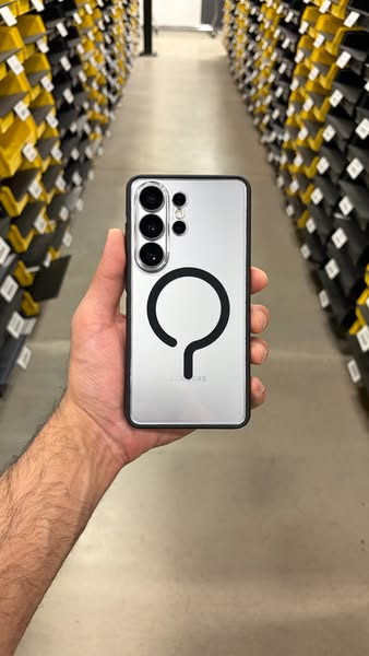 This ad showcases a silver Samsung smartphone with a black phone case. The phone is held up against the background of st